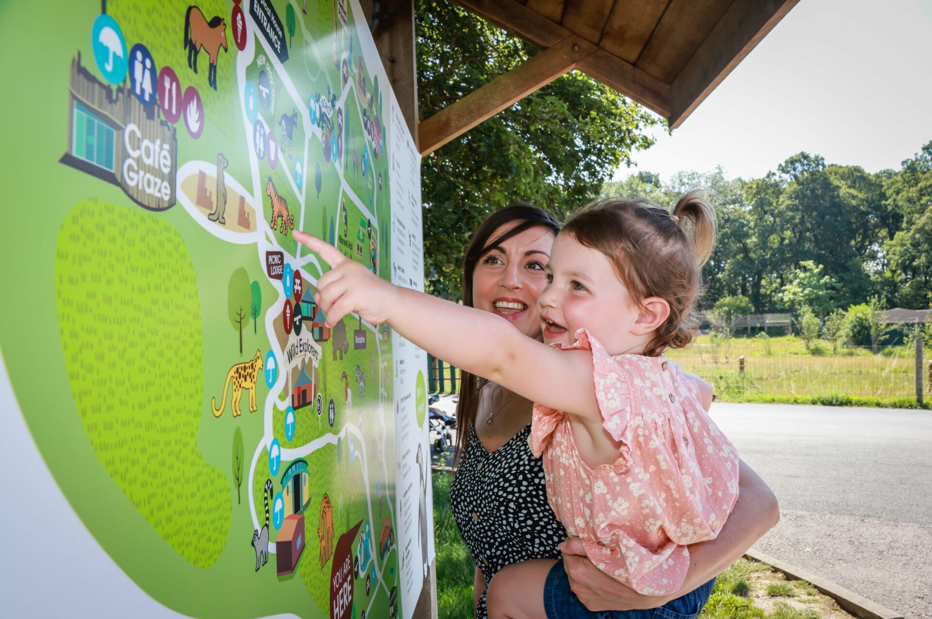 Girl with mother pointing at Map