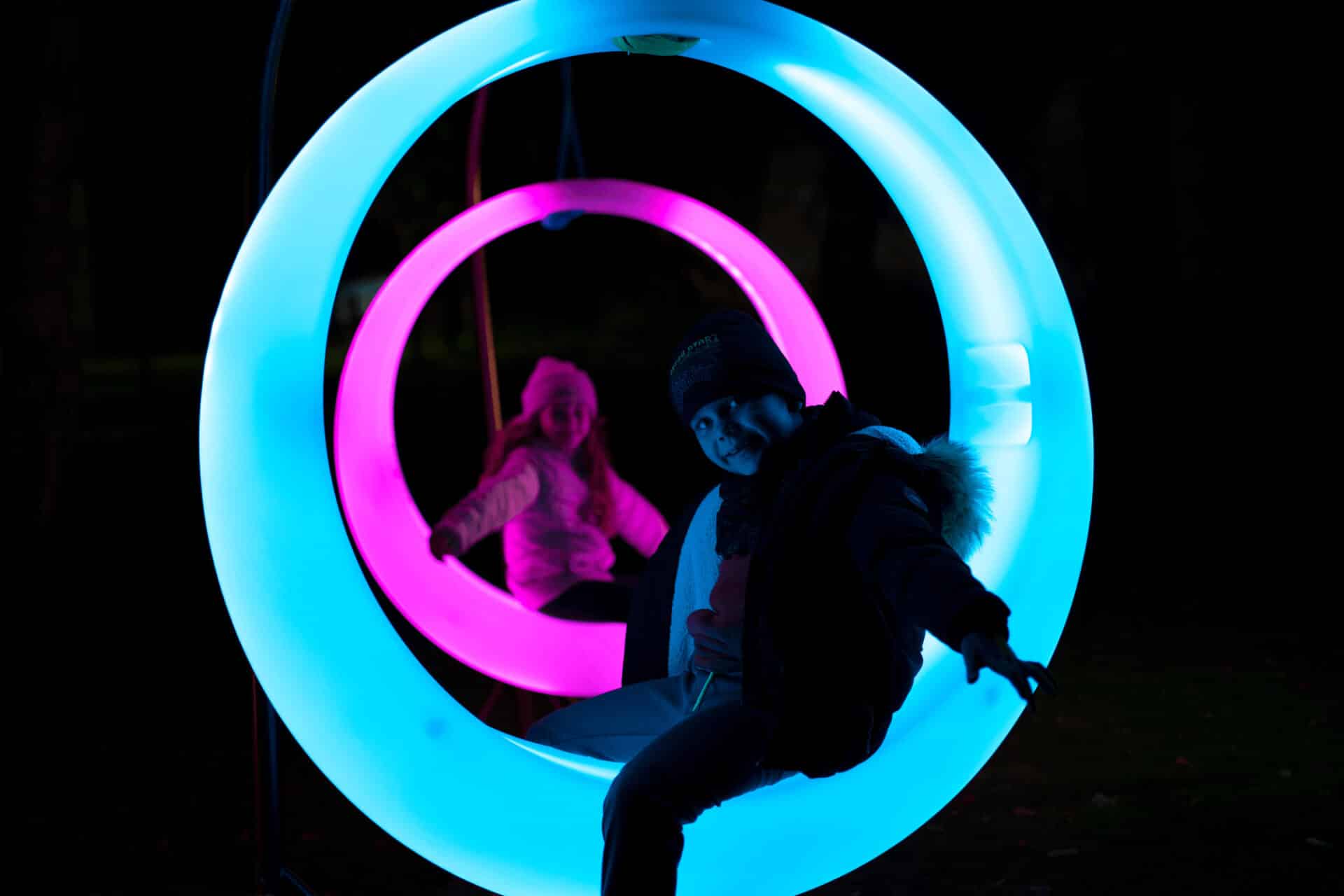 A young bow sits on a glowing blue moon chair at marwell zoo