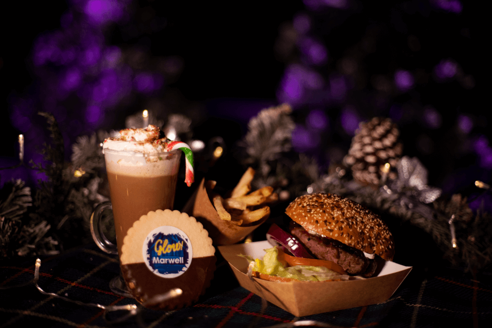 A christmas hot chocolate with candy cane, branded cookie and cranberry burger and fries chips