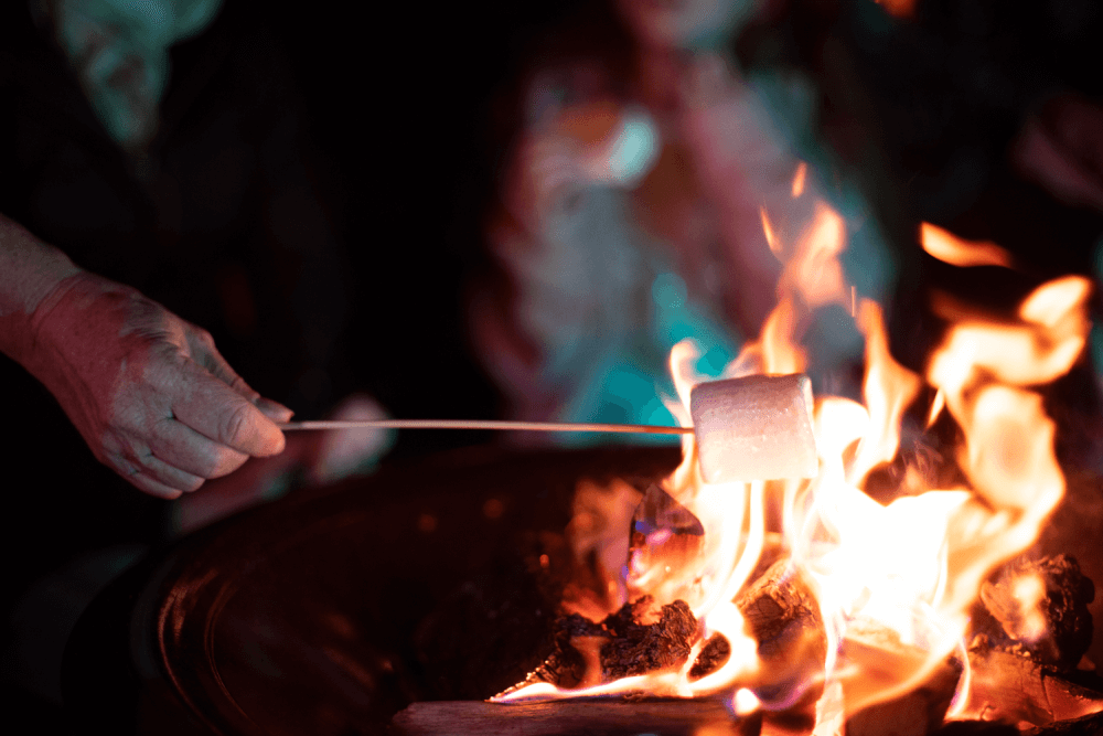 A marshmallow being roasting in a fire pit