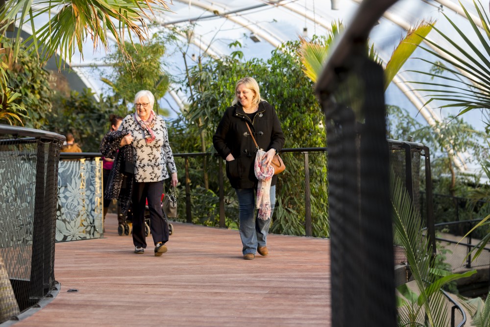 Two older ladies walk through Energy for Life Tropical House at Marwell Zoo