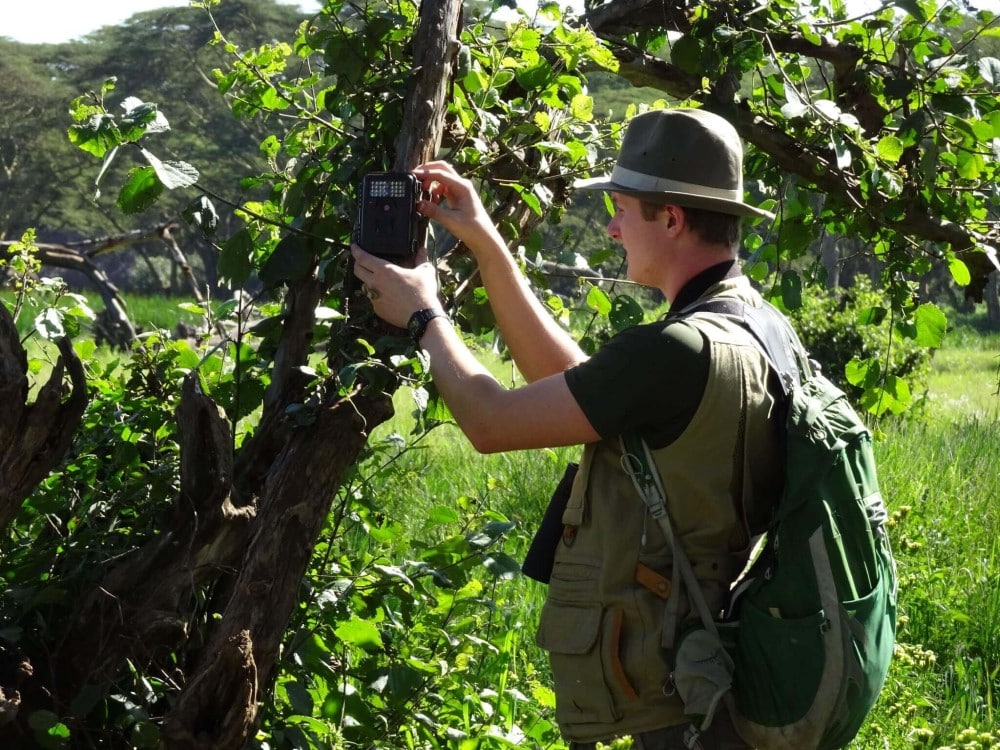 George Syder setting camera traps to monitor biodiversity in Kenya