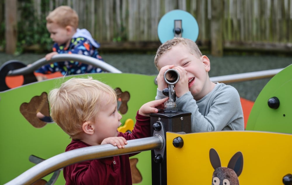 Toddlers play with the telescope on the new playground at Marwell Zoo