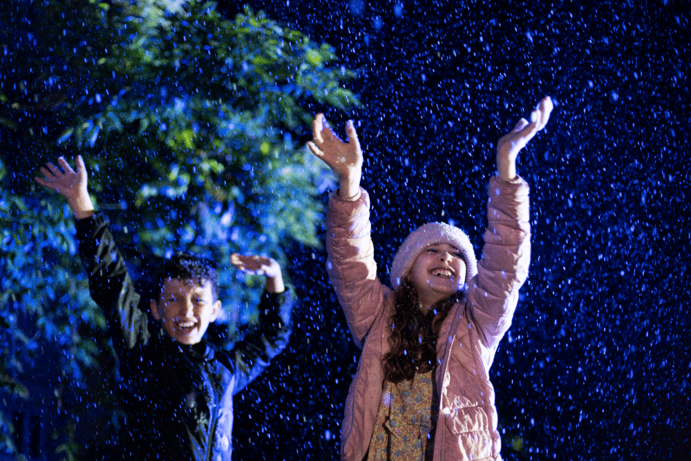 Children enjoy snow at Marwell Zoos Glow Marwell christmas light event