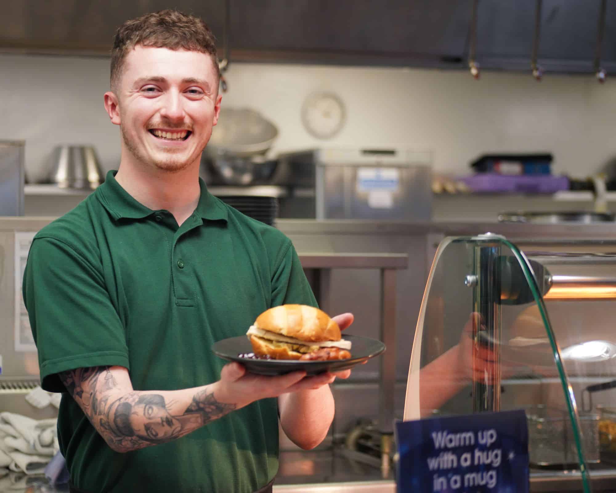 Marwell staff holding a tasty turkey bun on offer at Glow Marwell