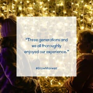 An image of two girls roasting marshmallows by a twinkling wall of fairy lights. Text in the middle reads: "Three generations and we all thoroughly enjoyed our experience." #Glow Marwell