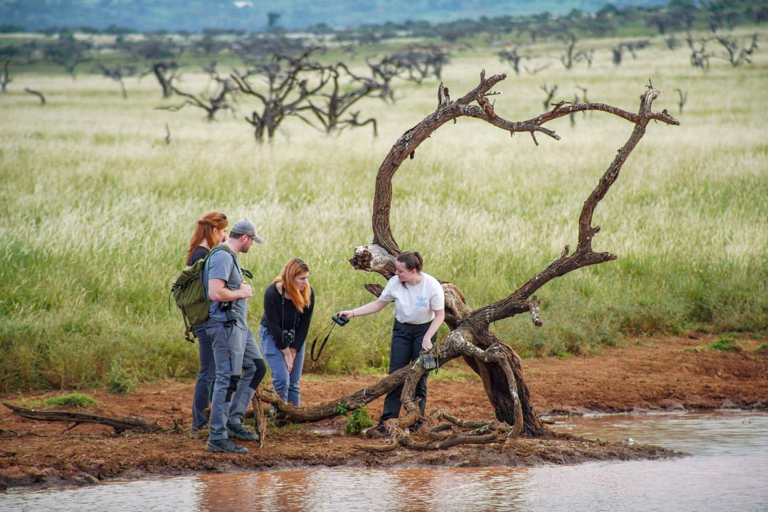 Marwell Wildlife MRes students setting camera traps at a man-made watering hole at Lewa Conservancy