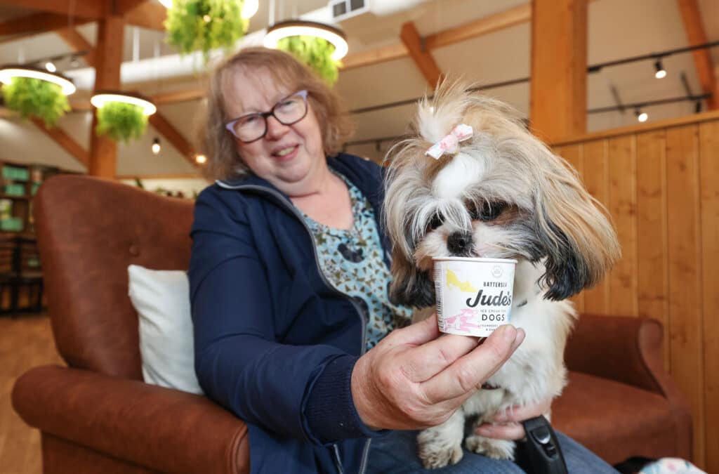A woman in The Keeper's Kitchen feeding her dog Jude's Ice Cream for Dogs