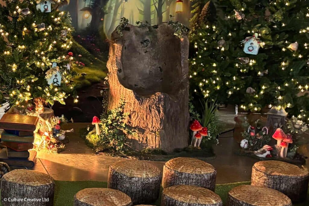 A woodland grotto experience at Marwell Hall, with logs where children can settle down for storytelling