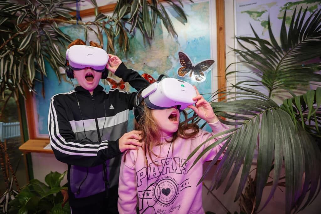 Two children with virtual reality experience headsets on at Marwell Zoo