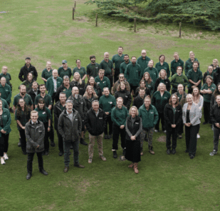 Some of the Marwell Wildlife staff an the lawn outside Marwell Hall