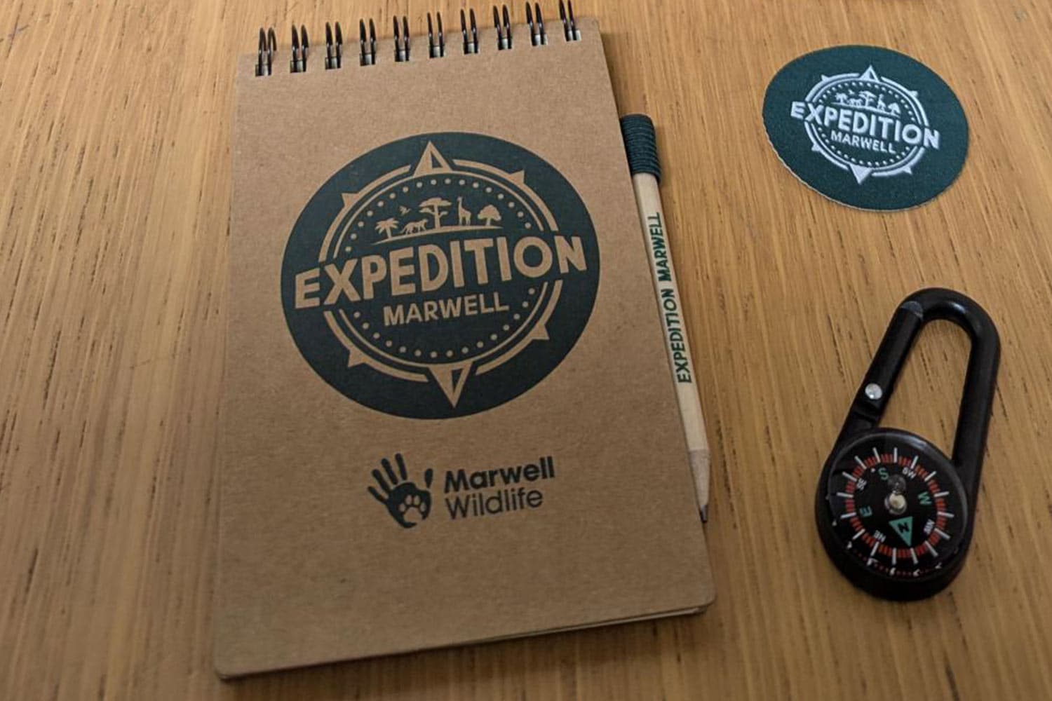 Expedition Marwell gift bag with notebook, pencil, soft badge and compass clip.