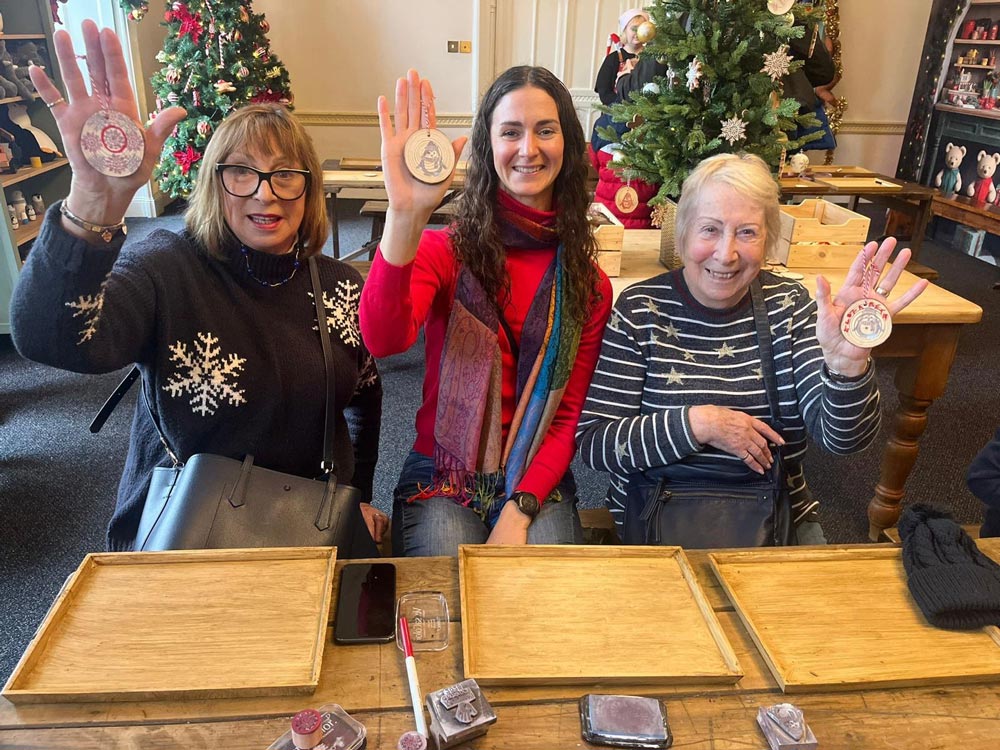 Nonagenarian Nannie Liz McDonald and her family with craft decorations at Marwell Zoo's Christmas at Marwell Hall event. Photo provided by Liz McDonald / Siobhan Mason