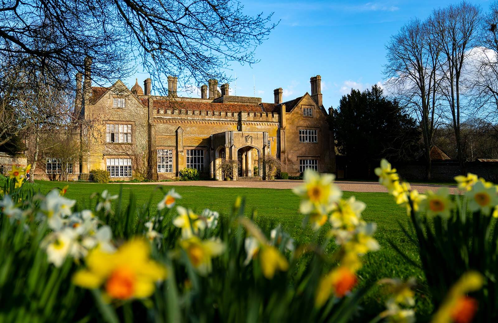 Marwell Hall, a historic house at Marwell Zoo, with daffodils