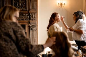 A bridal party prepare for their wedding day in the Seymour Library at Marwell Hall