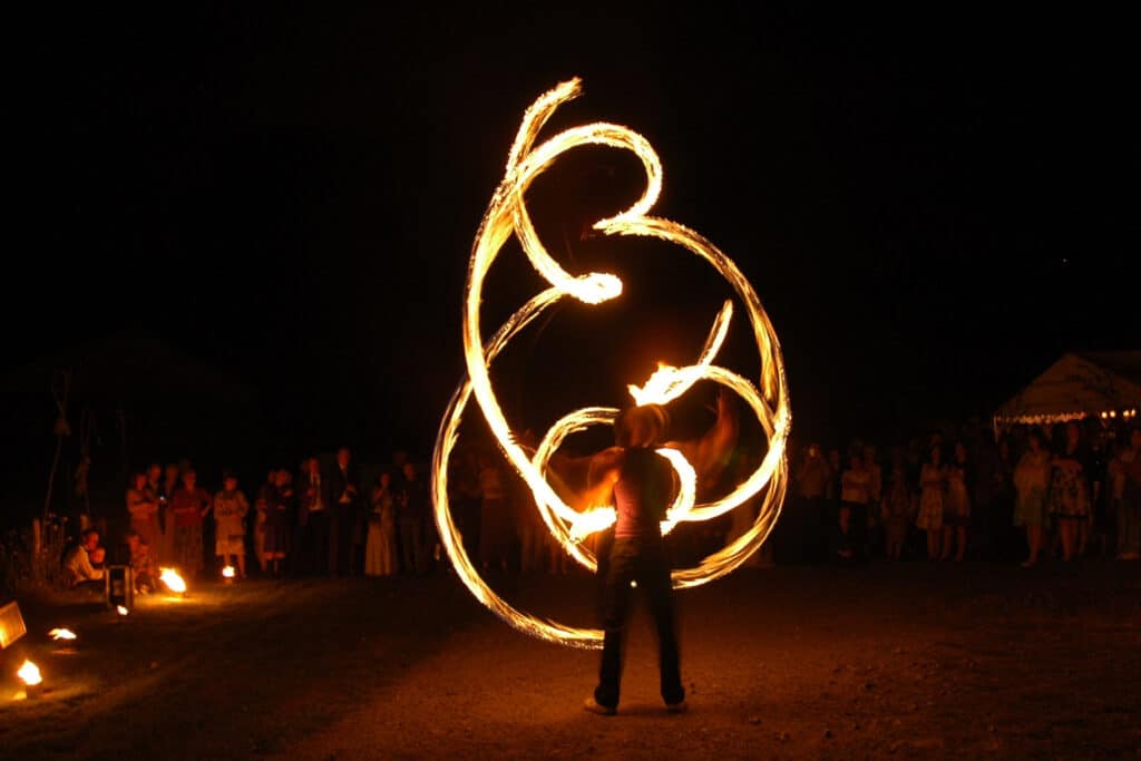 A fire performer juggles with balls of fire