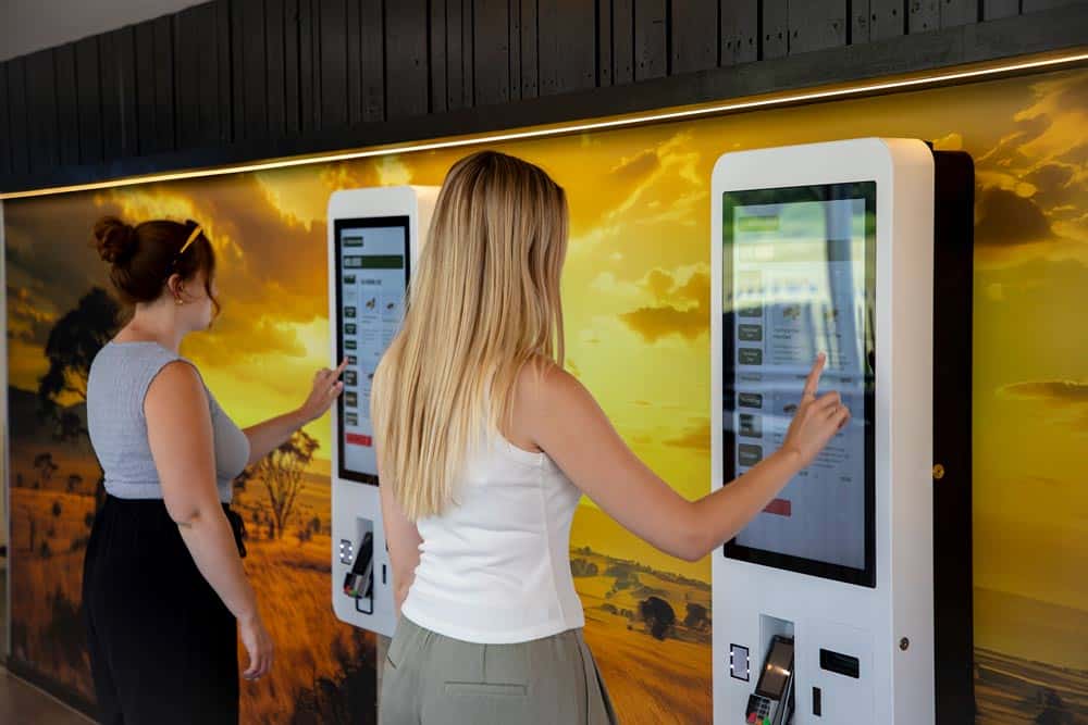 Two guests order from the digital kiosks at Cafe Graze in Marwell Zoo
